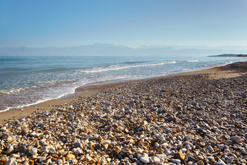Fototapeta na wymiar Pebble beach of the island of Corfu.