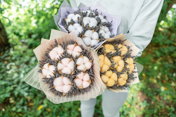 three beautiful and different bouquets lavender with cotton in woman hands . dried flowers lilac...