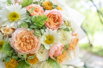 Beautiful summer bouquet. Arrangement with mix flowers. Young girl holding a flowers bunch. The concept of a flower shop. Content for the catalog