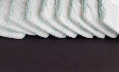 Baby diapers on a black background, diaper