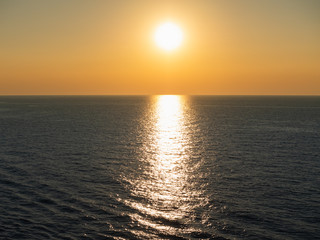 Obraz premium Magical sunset on the background of sea waves. View from cruise ship on the open sea