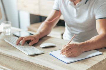 Taking notes. Close up of a notebook lying on the table while being used for writing notes