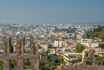 summer view of travel in Greece, tourism is the old ruins of the ancient city on the background of the city of Athens