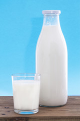 Dairy products. Bottle with milk and glass of milk on wooden table