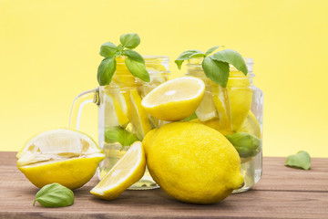 homemade refreshing summer lemonade drink with lemon slices and ice in mason jars