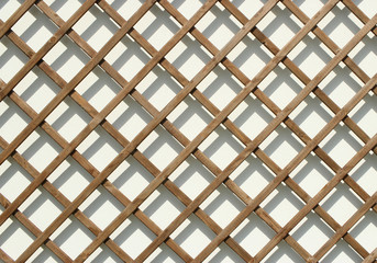 Geometric texture from garden. Wooden construction with shadows. 