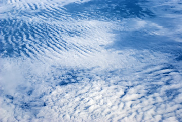 Obraz premium view from the plane above the clouds and the ground