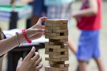 Girl building a tower of wooden blocks
