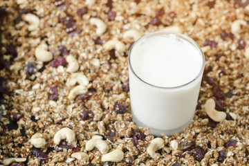 Glass of yogurt, granola on the background. Tea spoon. Food Concept