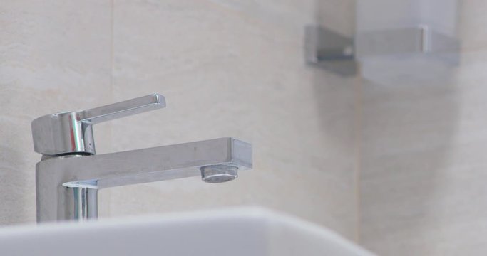 water droplets on tap in batroom leaking