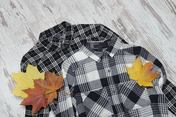 Two checkered shirts and maple leaves. Fashionable concept