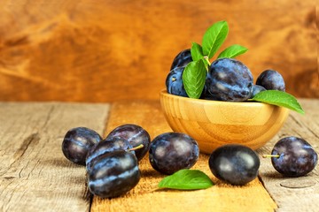 Fresh plums on a wooden table. Fruit harvest. Sales of fresh fruit.