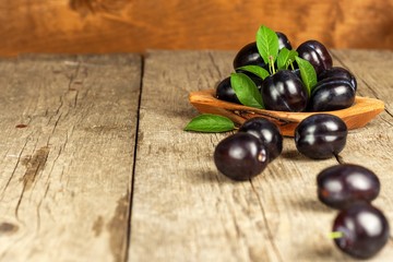Fresh plums on a wooden table. Fruit harvest. Sales of fresh fruit.
