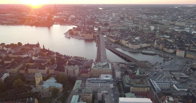 Aerial view oft he Old Town in Stockholm Sweden during a beautiful sunset. Majestic colours of in the sky. The drone flies backwards revealing more of this beautiful urban scene.