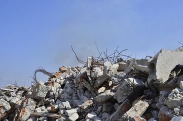 The rebar sticking up from piles of brick rubble. In the background, you can see the remnants of smoke clubs