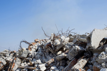 The rebar sticking up from piles of brick rubble. In the background, you can see the remnants of smoke clubs