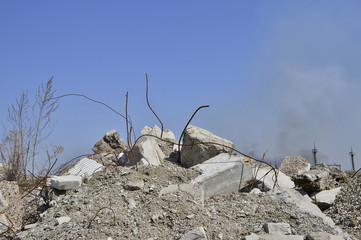 The rebar sticking up from piles of brick rubble. In the background, you can see the remnants of smoke clubs