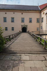Fototapeta na wymiar Wooden bridge with railing to the arch of the entrance to the castle. Transcarpathia Uzhhorod Ukraine