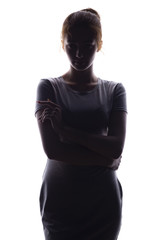 silhouette of confident young woman looking straight on a white isolated background