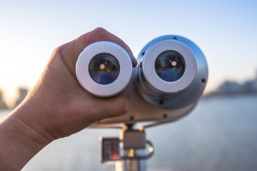 telescope with city skyline