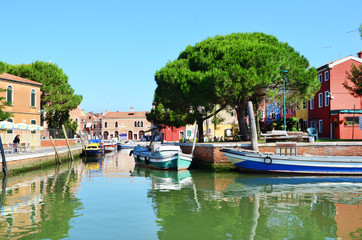 Fototapeta na wymiar BURANO, ITALY - JUNE 10,2016: Colorful Houses and Canals with Boats in Burano Island near Venice, Italy