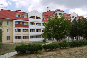 multistory hotel with a red roof and mansard windows for holidaymakers