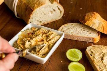 Hummus with sourdough bread on wooden jarrah board
