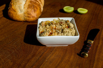 Hummus with sourdough bread on wooden jarrah board