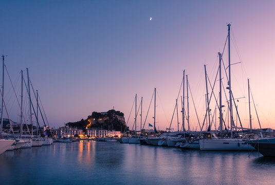 Denia Marina at sunset, with the famous medieval castle on the background. Alicante, Spain.