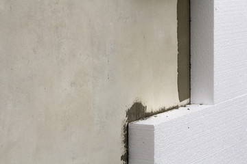Close-up detail of plastered house wall with rigid styrofoam insulation. Modern technology,...