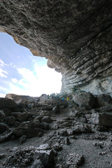 a gorge in the rocks with a pedestrian path with railing for tourists