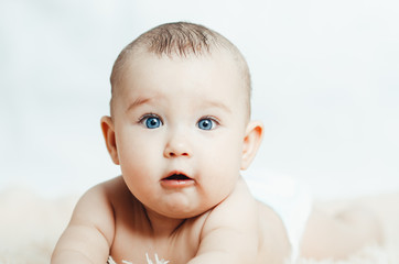 Small smiling baby with a toy