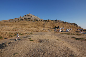 Fototapeta na wymiar tent camp on a mountainside with scant vegetation