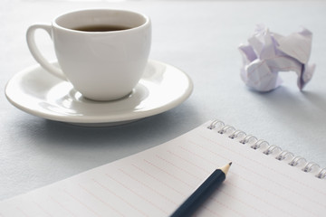  Notebook, pencil and cup of coffee. Close up. Business, education concept. Morning time