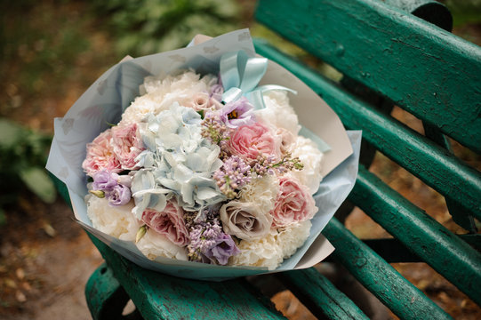 Fototapeta Beautiful bouquet of pastel color flowers on the bench