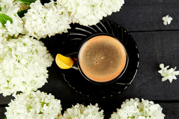 Cup of coffee with bouquet hydrangea