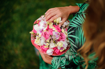 Top view girl holding a box of pink roses and white orchids