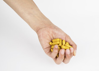 Vitamin And Supplement. Closeup Of Taking Yellow Fish Oil Pill. Hand Putting Omega-3 Capsule. Healthy Eating And Diet Nutrition Concepts. High Resolution Image.