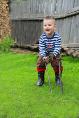 The boy with an iron hammer to drive a metal rod