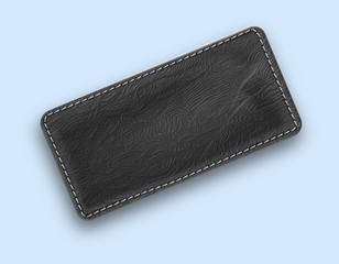 Leather black realistic stitched rectangle. Textured tag with shadow.