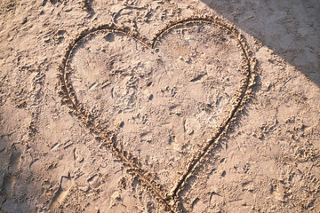 Hand draw heart on the beach sand