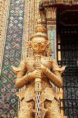 Elegant golden giant guardian statue of Bangkok Grand Palace building - Wat Phra Kaew - Emerald Buddha Temple