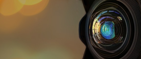 Close up of a large camera lens with bokeh background  and copy space .