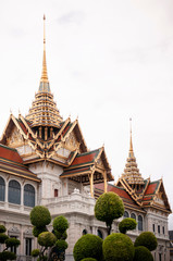 Fototapeta na wymiar Golden artisan facade and roof of Bangkok Grand Palace 