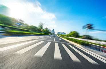 empty asphalt road with city skyline