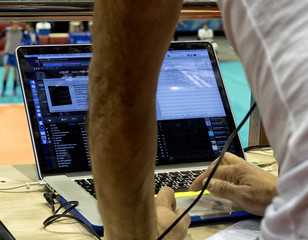 music, technology, people and equipment concept - hands using mixing console in sound recording...