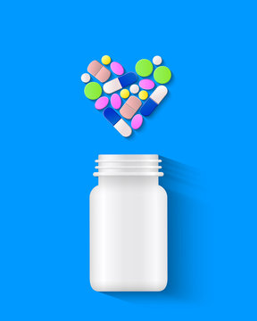Pills, tablets and capsules arranged in heart shape with white pill bottle on blue background as health concept