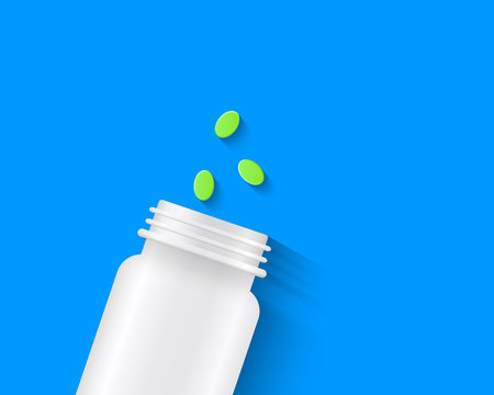 Green pills with white pill bottle on blue background