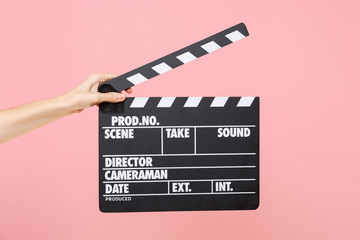 Close up female holding in hand classic director clear empty black film making clapperboard...