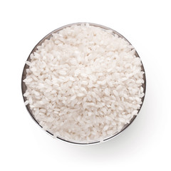 Uncooked white rice in bowl isolated